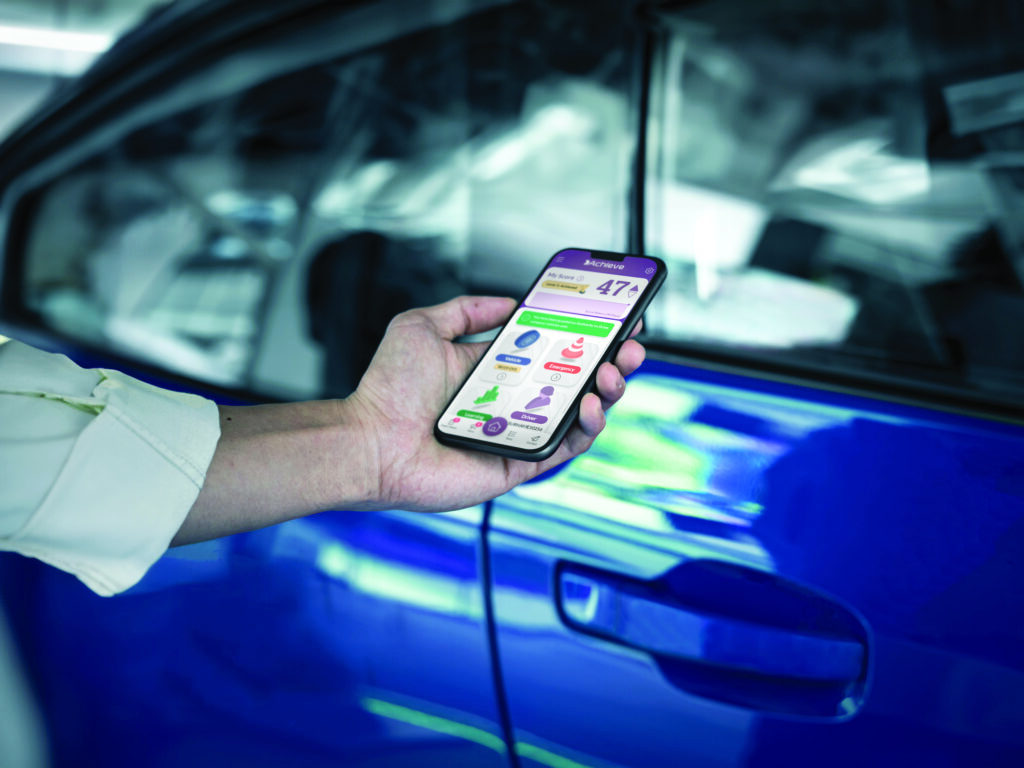 person using fleet management app next to vehicle