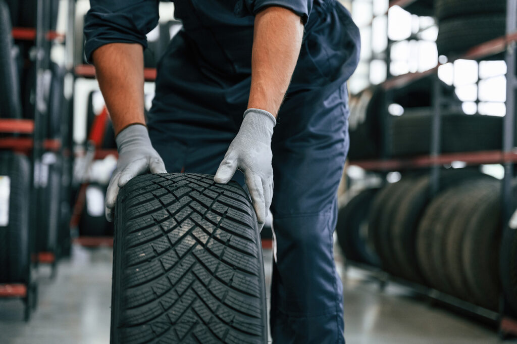 Mechanic checking tyre during MOT