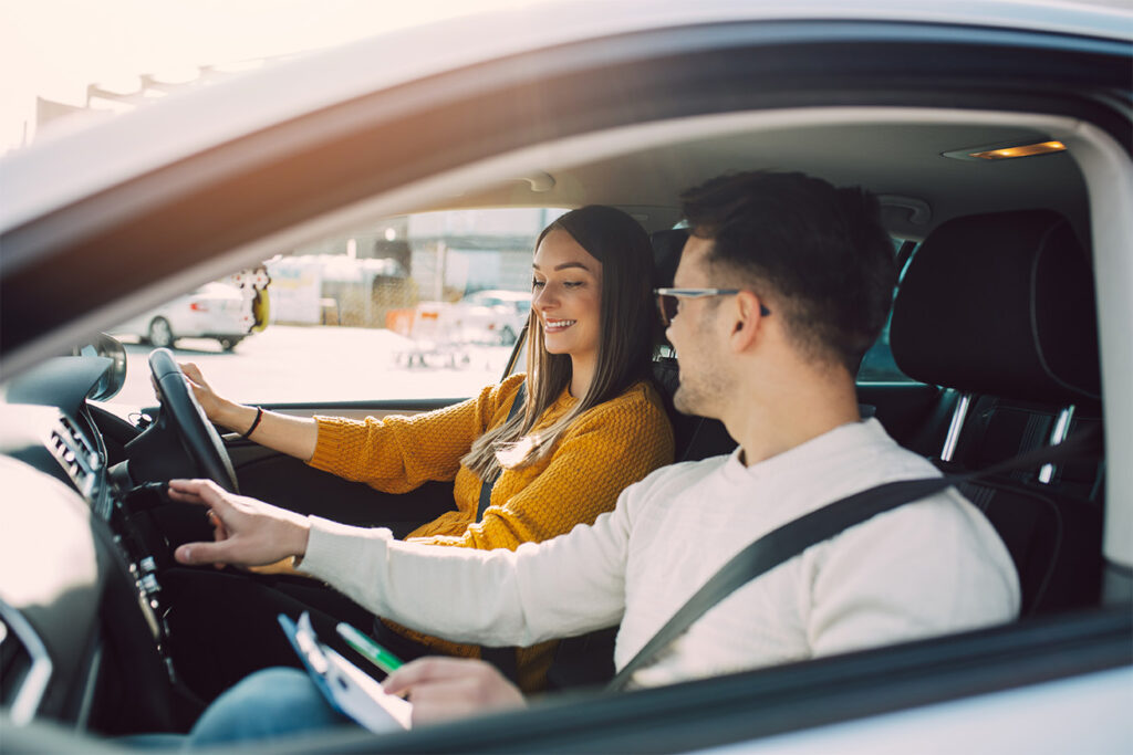 women getting a driving lesson in car