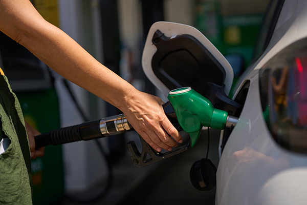 Person putting fuel into car