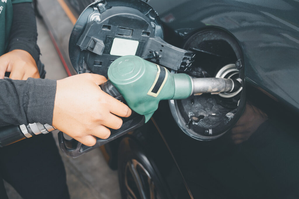 person filling up vehicle with diesel