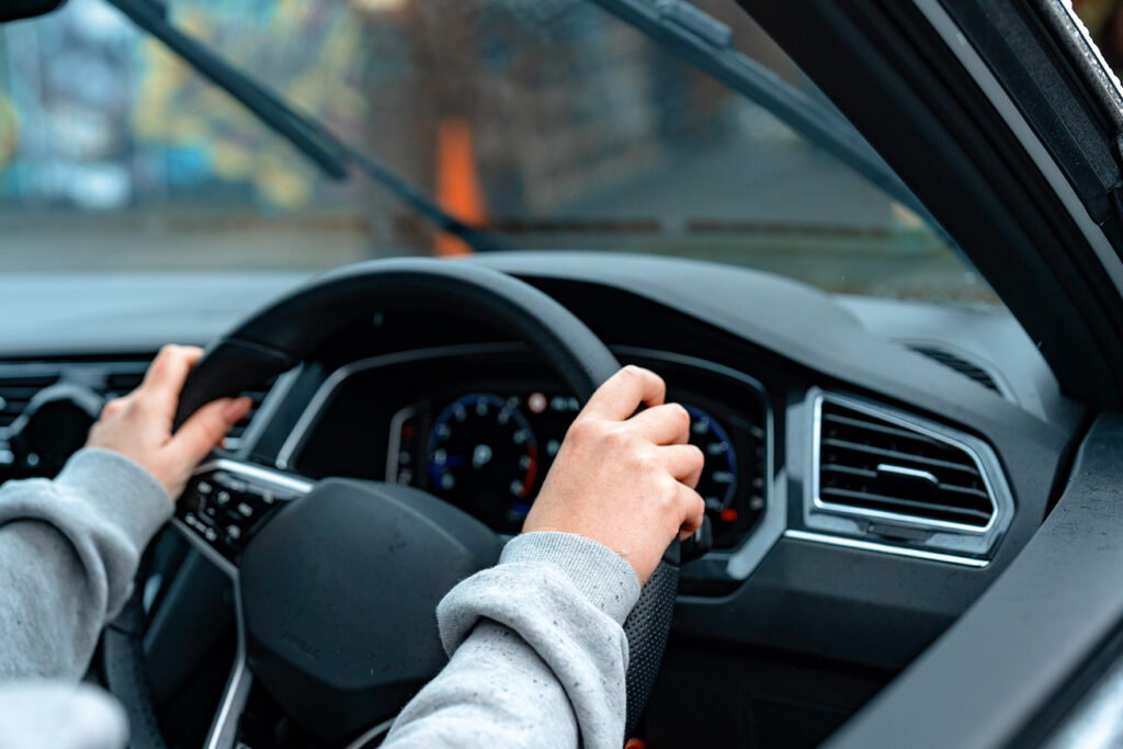 person holding steering wheel driving